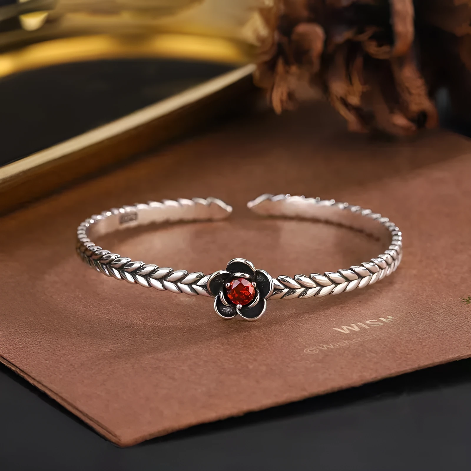 Silver zinc alloy retro bracelet with red zirconium plum flower centrepiece on white background