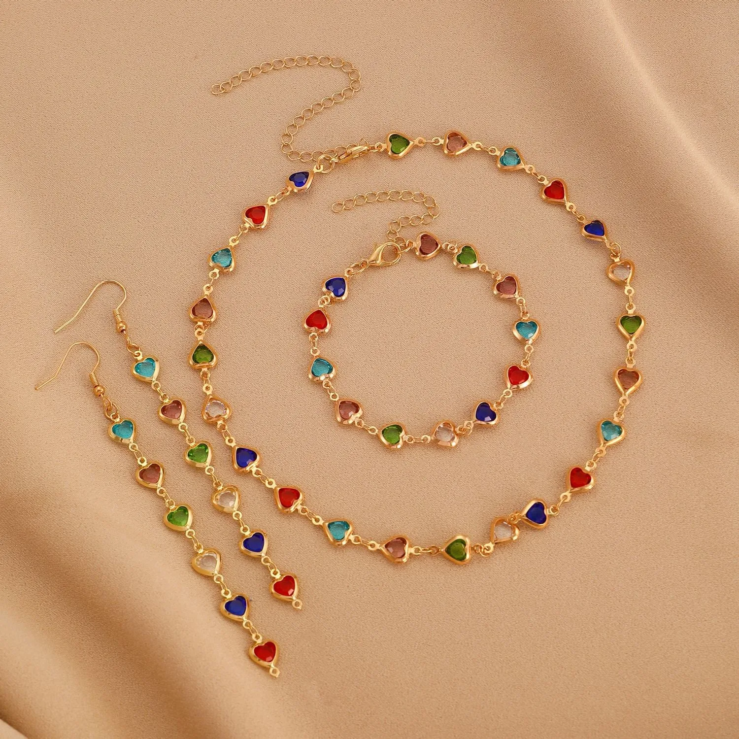 Women's colourful water drop tassel earrings in gold-tone electroplated copper on a plain background