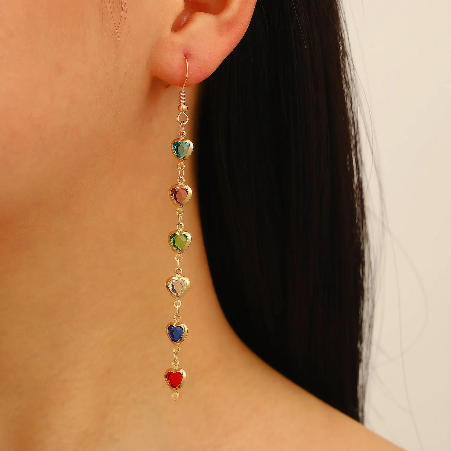 Women's colourful water drop tassel earrings in gold-tone electroplated copper on a plain background