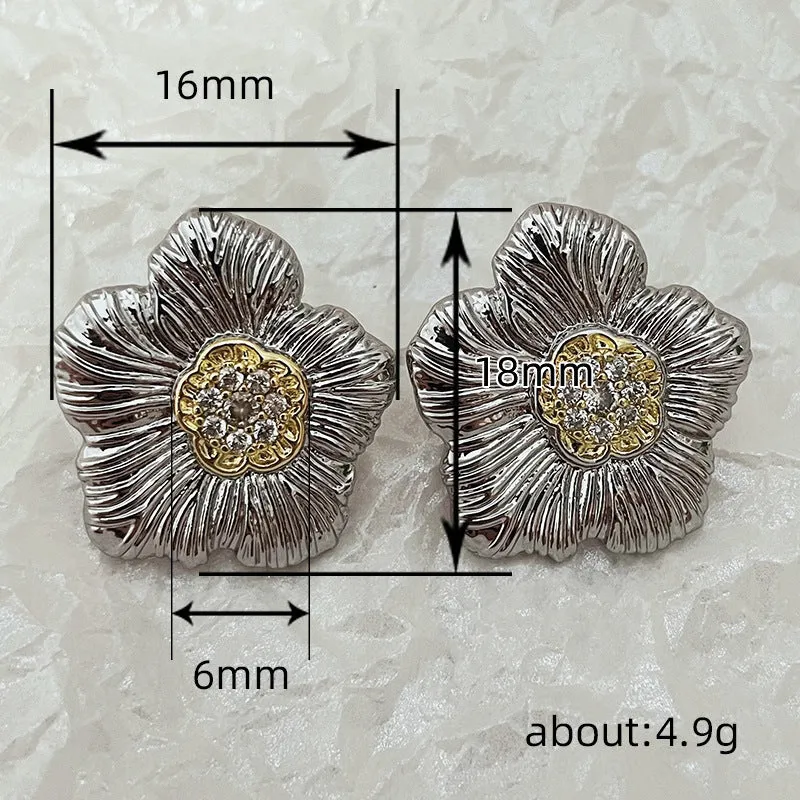 Close-up of retro textured gardenia stud earrings in two-tone copper with floral petal detail.
