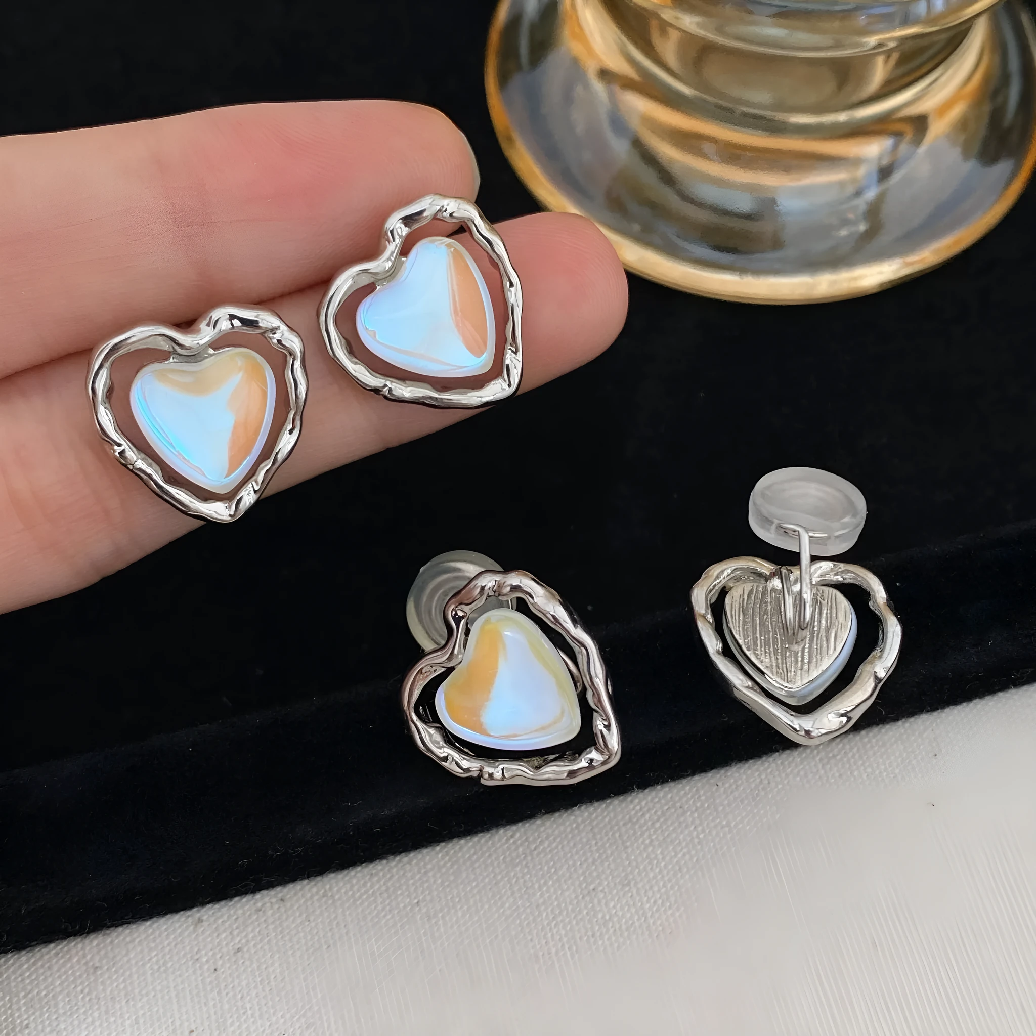 Women's alloy geometric heart earrings in ear clip and ear stud styles with electroplated finish