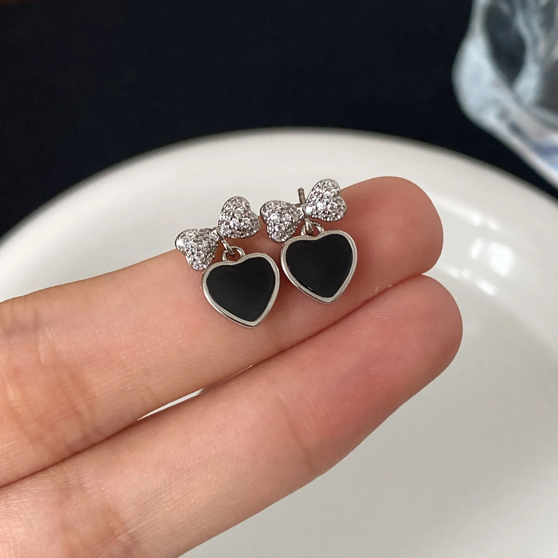 Pair of women's copper earrings, one heart-shaped and one bow-shaped, with micro-set zircon stones, ear clip and ear stud options