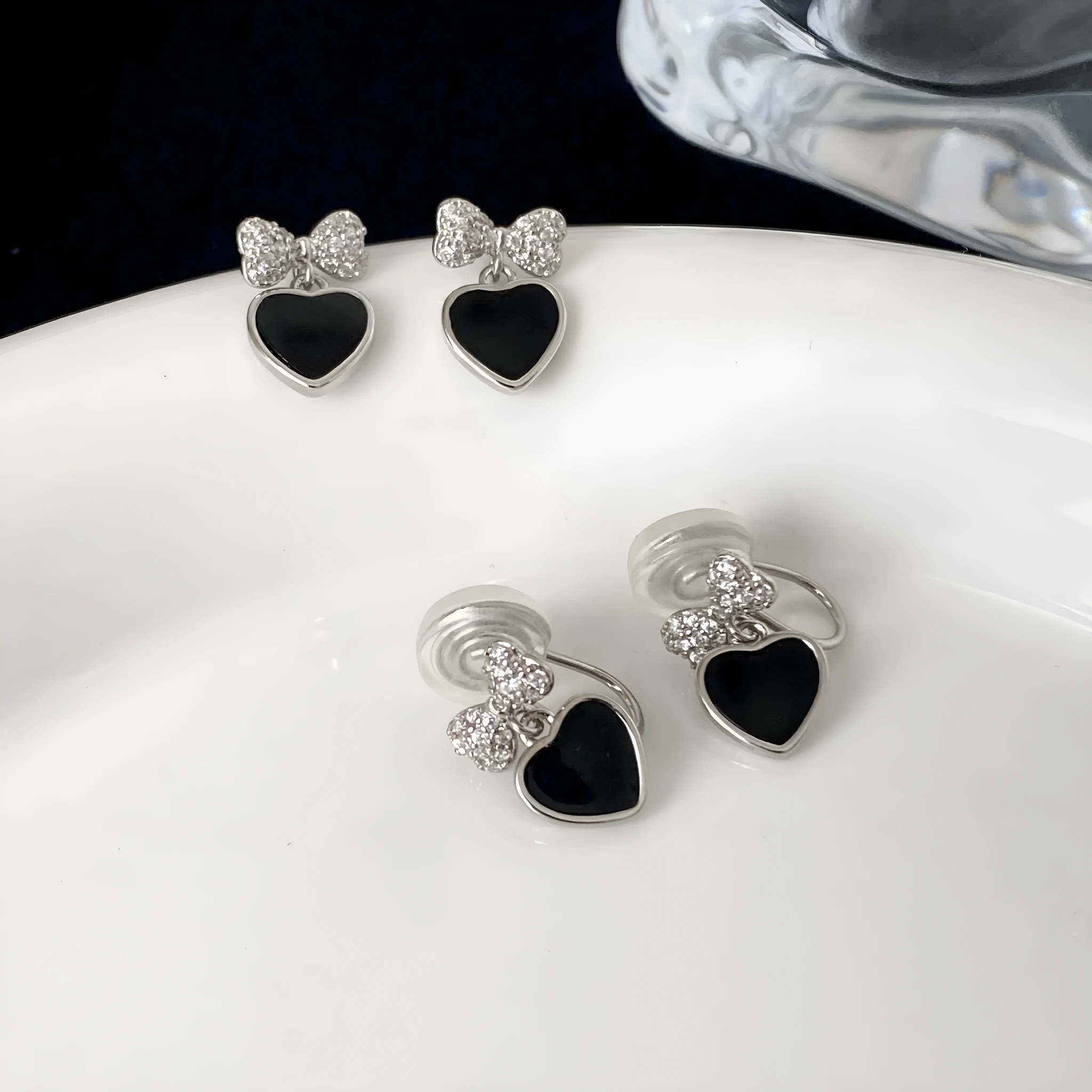 Pair of women's copper earrings, one heart-shaped and one bow-shaped, with micro-set zircon stones, ear clip and ear stud options