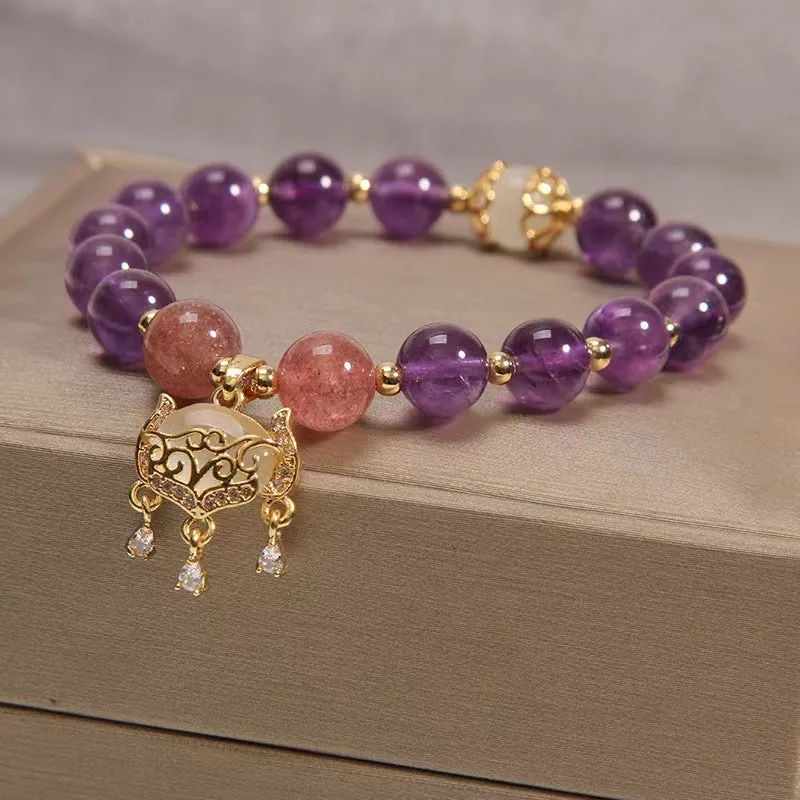 Handmade copper bracelet for women with a natural amethyst drop charm and longevity lock symbol.