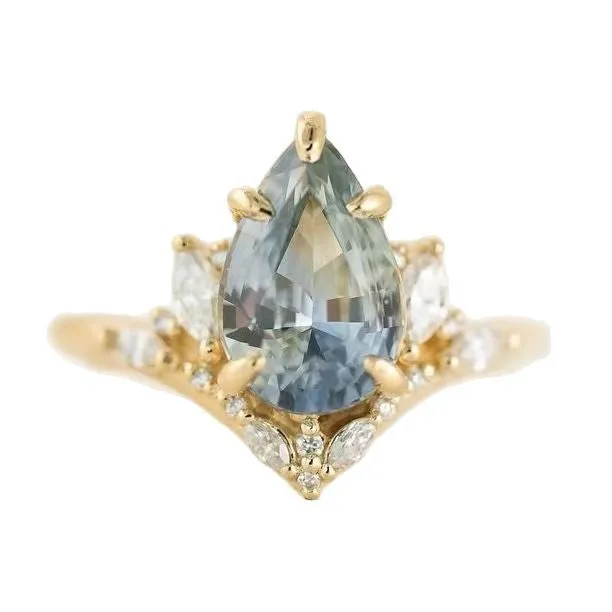 Gold alloy floral ring with aquamarine crystal centre on white background
