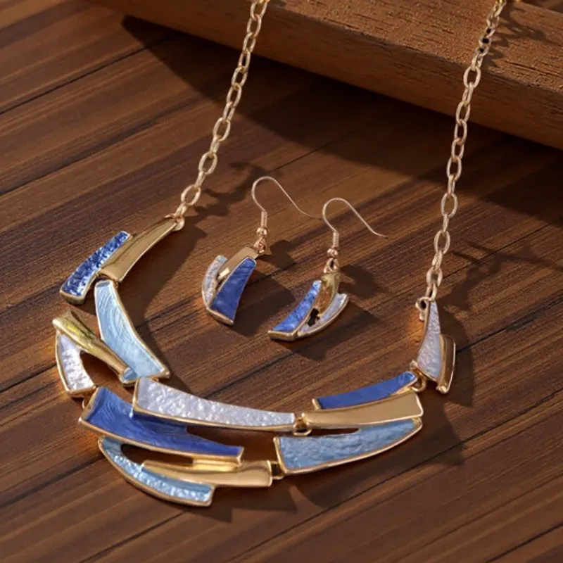 Blue zinc alloy quadrilateral pendant necklace and matching earrings set on display with twist link chain