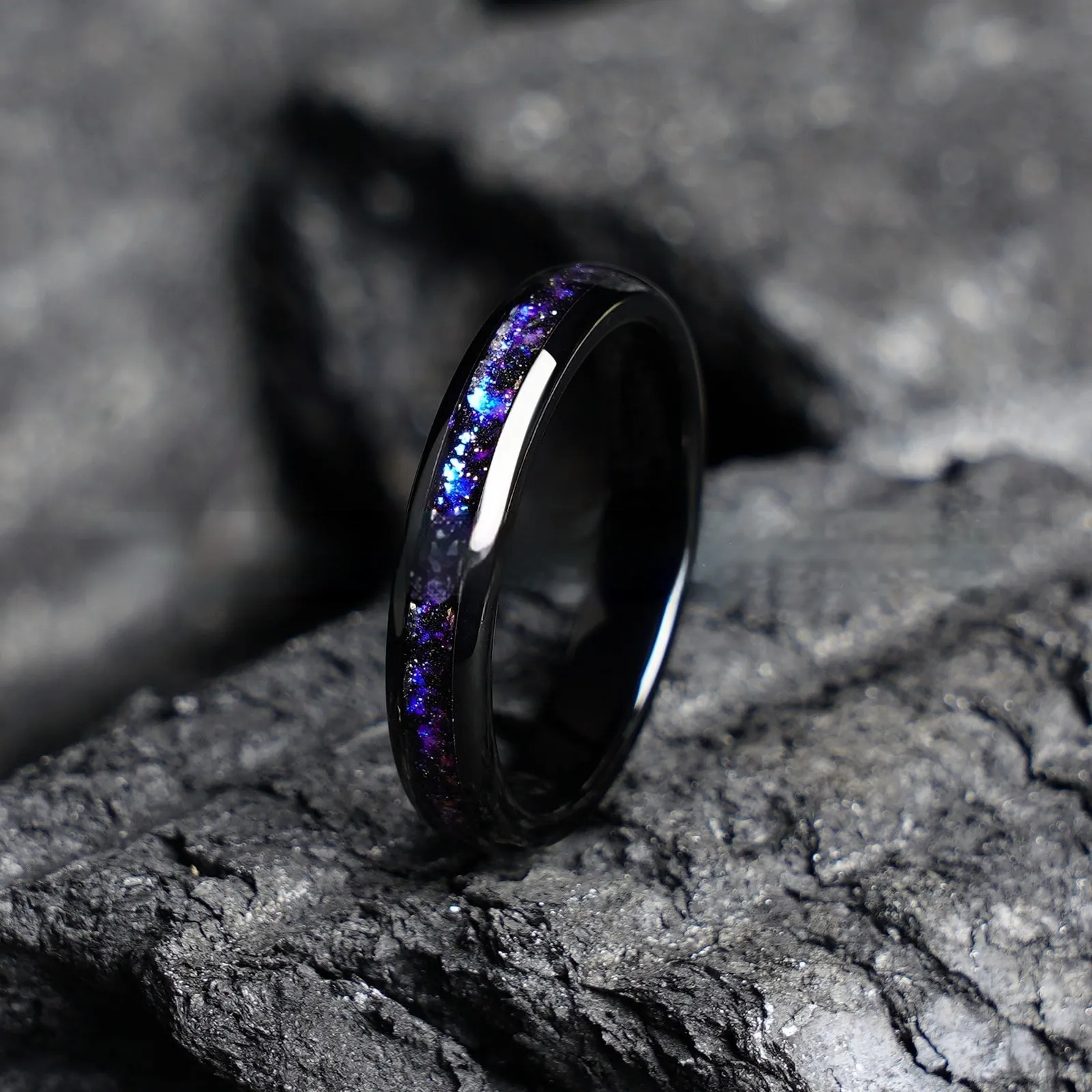 Galaxy tungsten ring with electroplated black finish and coloured inlay on a plain background