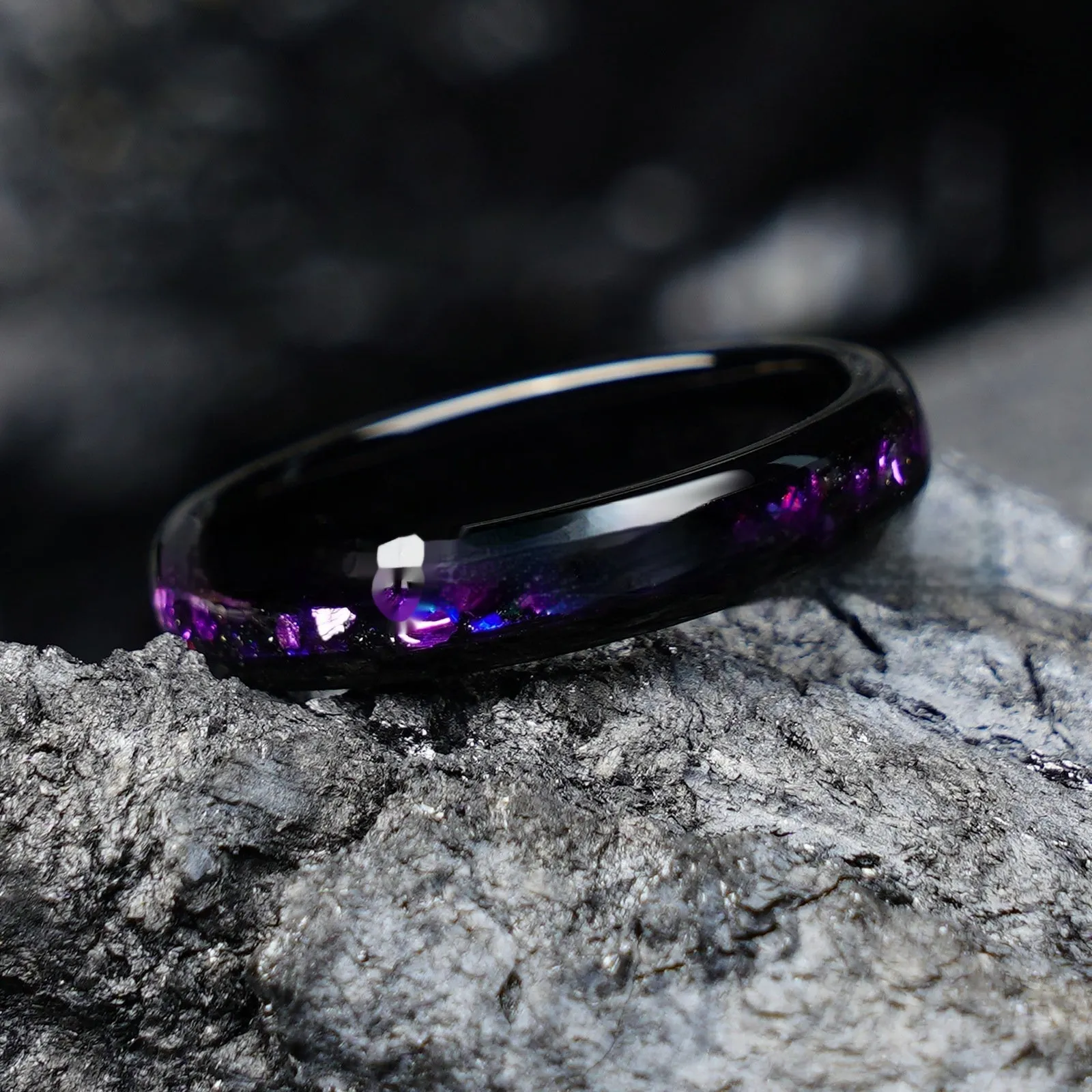 Galaxy tungsten ring with electroplated black finish and coloured inlay on a plain background