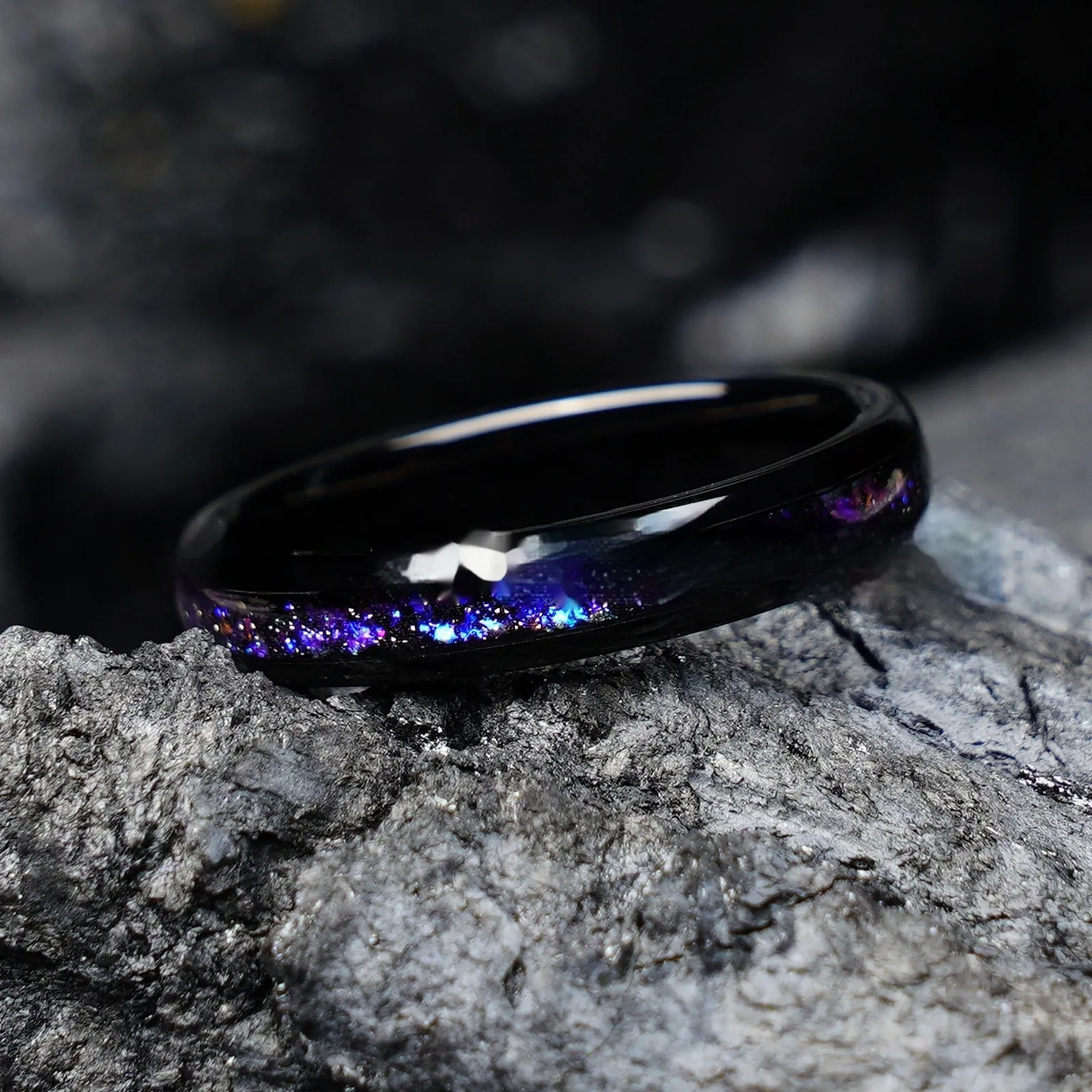 Galaxy tungsten ring with electroplated black finish and coloured inlay on a plain background