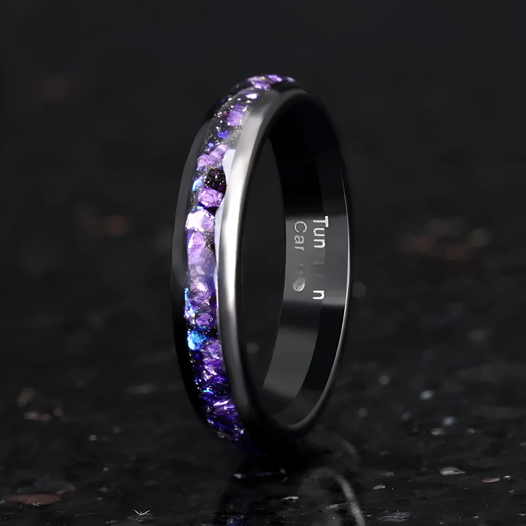 Galaxy tungsten ring with electroplated black finish and coloured inlay on a plain background