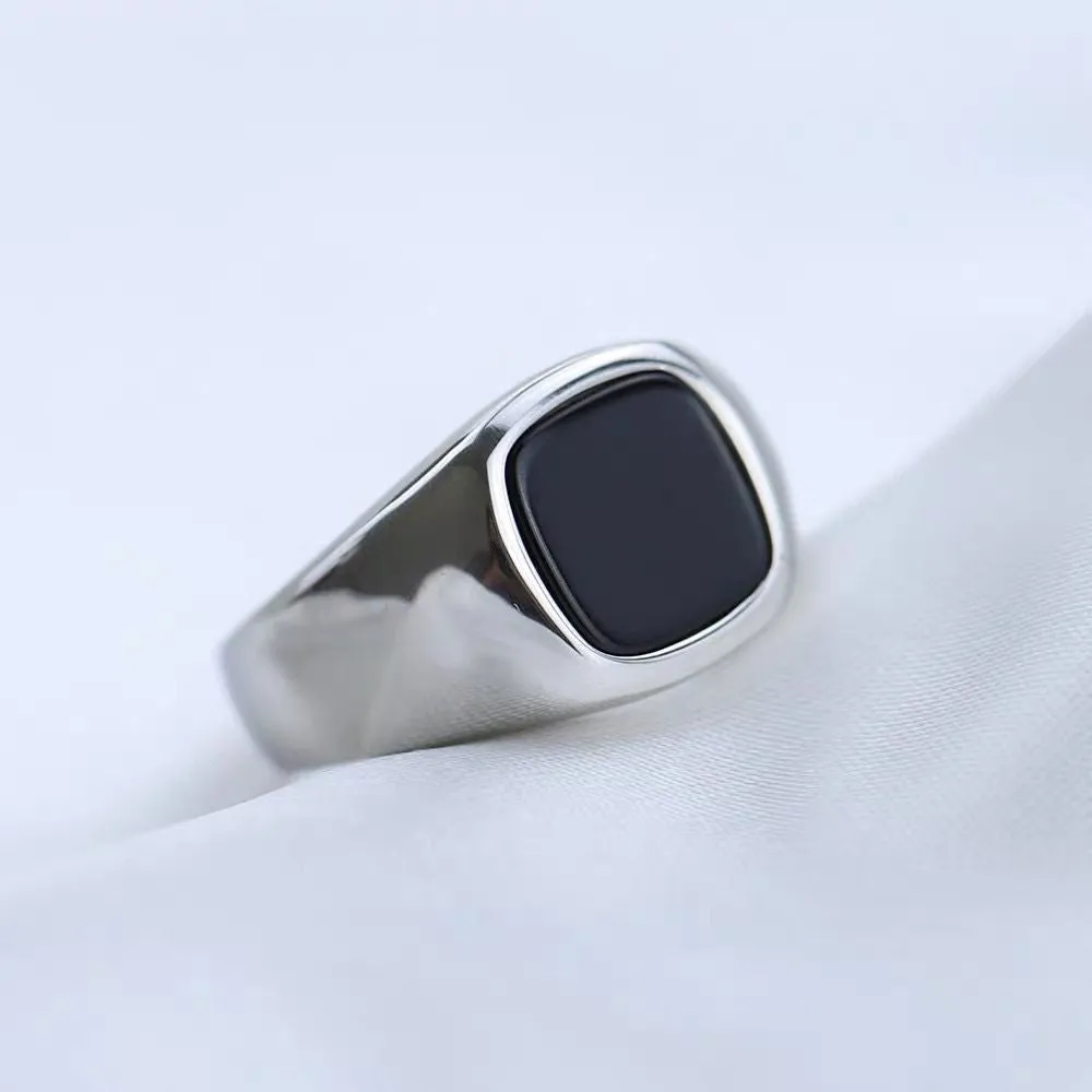 Titanium steel hexagonal men's ring with glossy black epoxy inlay on white background