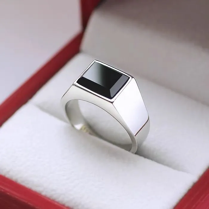 Titanium steel hexagonal men's ring with glossy black epoxy inlay on white background