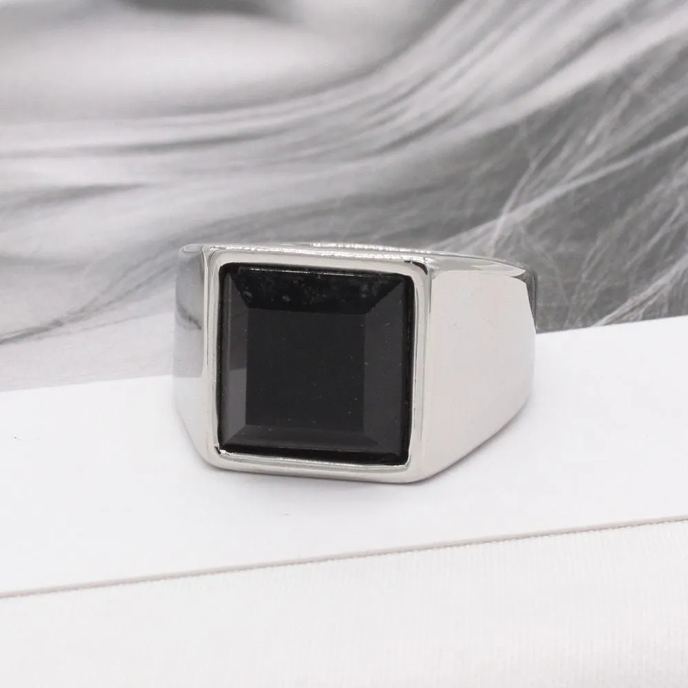 Titanium steel hexagonal men's ring with glossy black epoxy inlay on white background