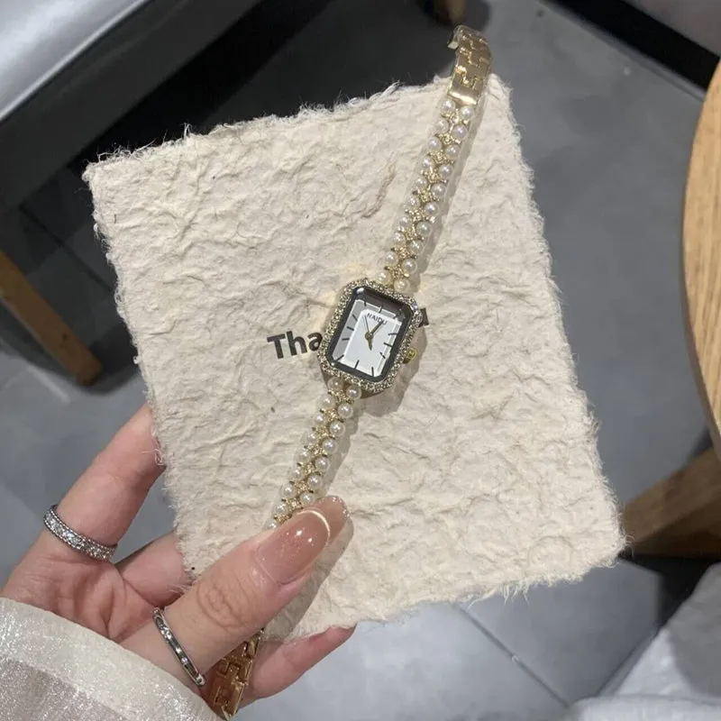 Women's fashion pearl bracelet watch with 30mm round dial, alloy strap, and quartz movement on white background