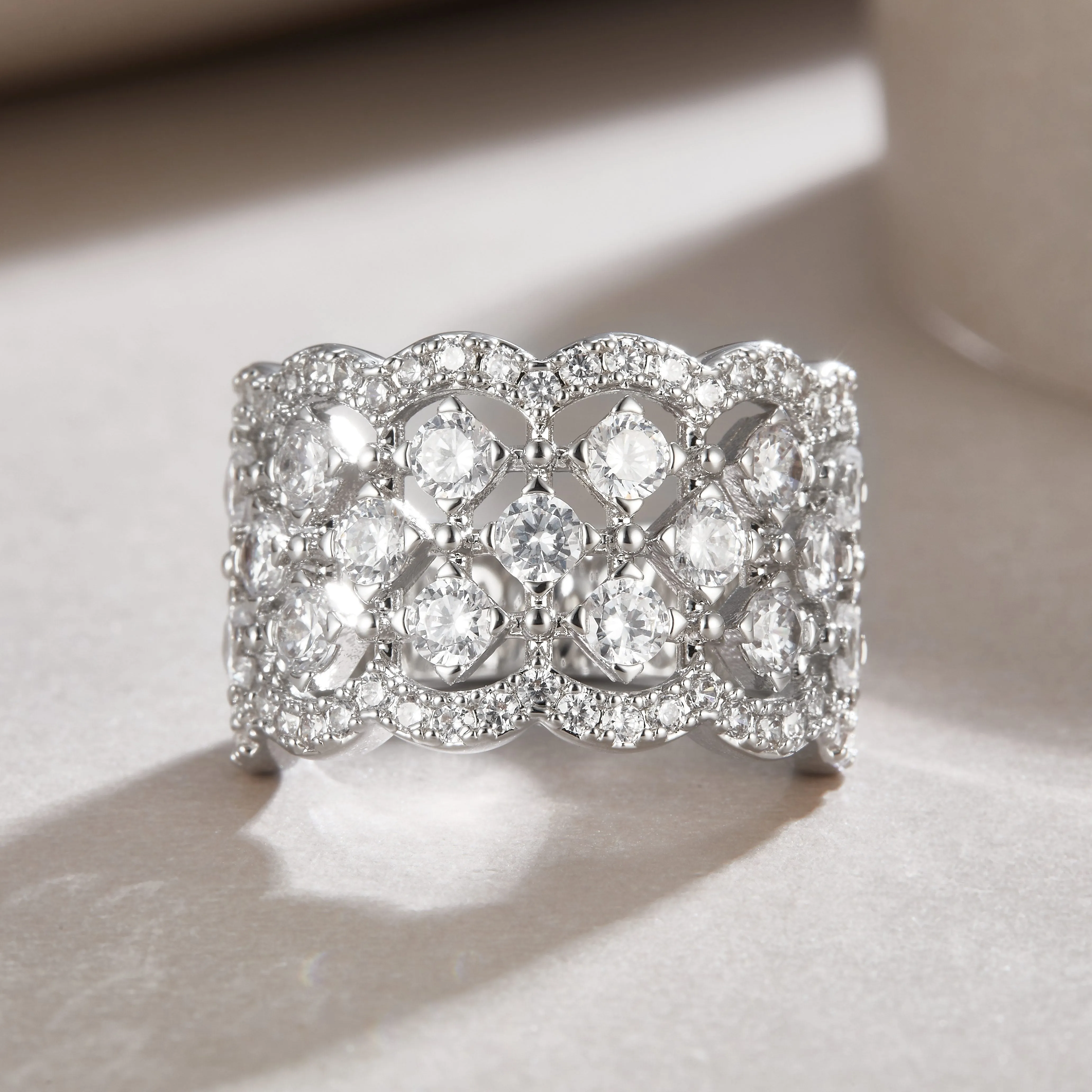 Lace Snowflake moissanite wedding ring set in S925 silver with platinum plating on a black background