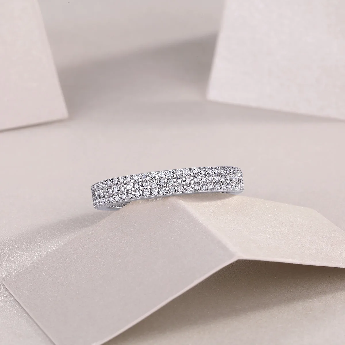 Moissanite wedding ring set in S925 silver with platinum plating, yellow gold colour, on white background