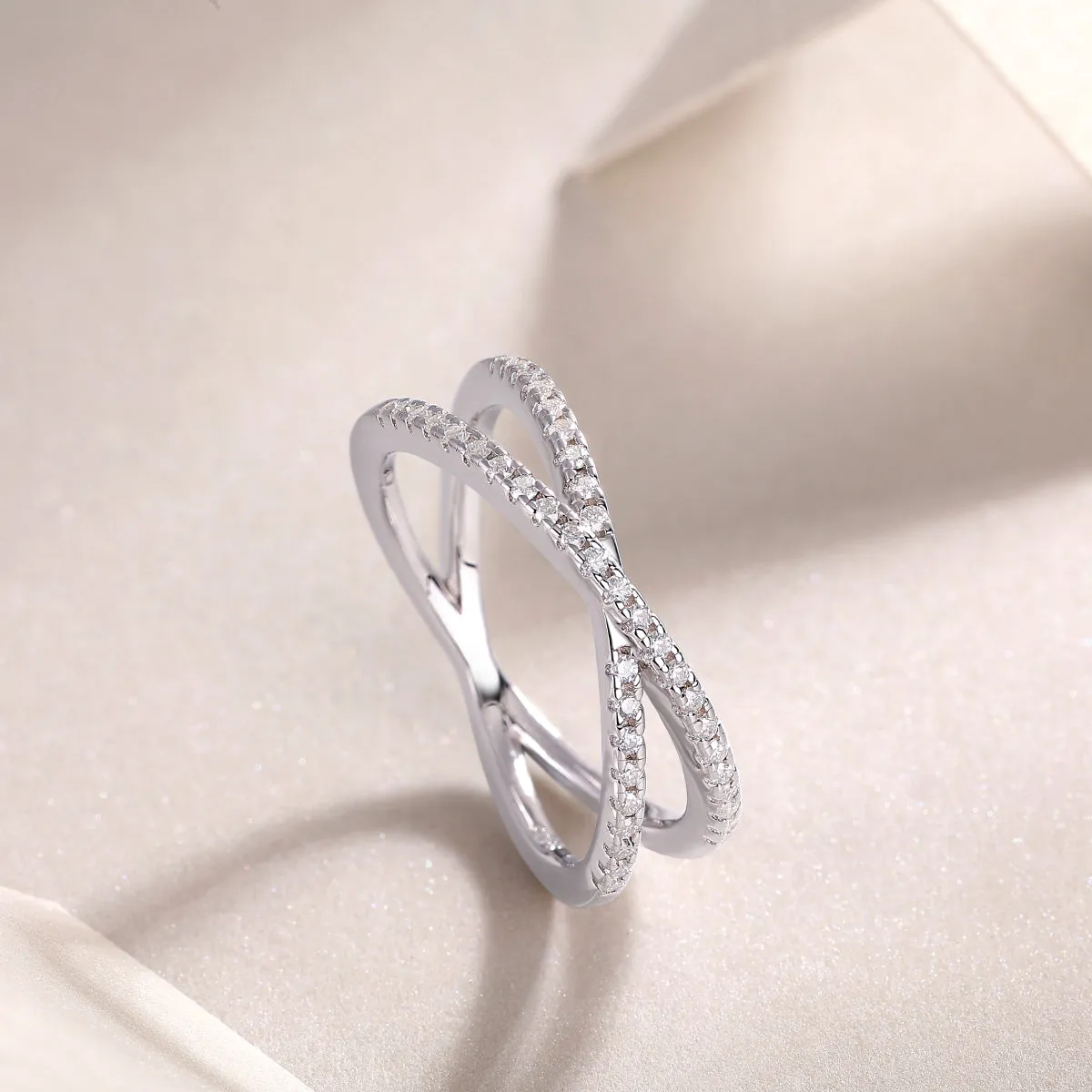Love Interwoven moissanite wedding ring set in gold finish, S925 silver platinum plated, on white background with gift box.