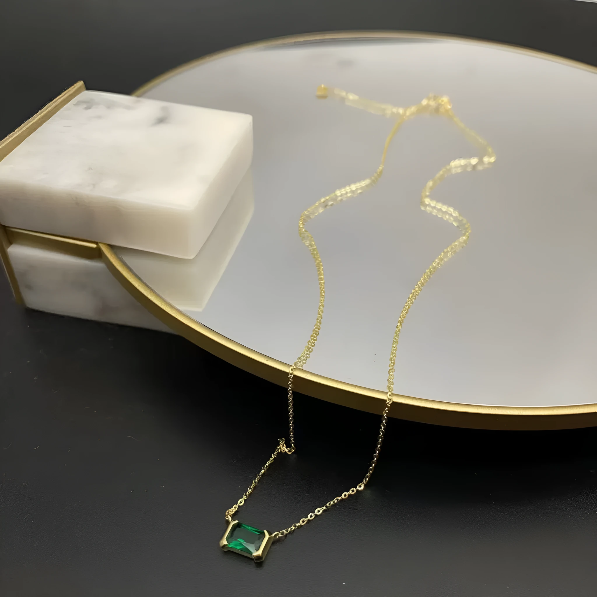 Women's gold geometric pendant necklace with quadrilateral design and inset cubic zirconia stones on chain