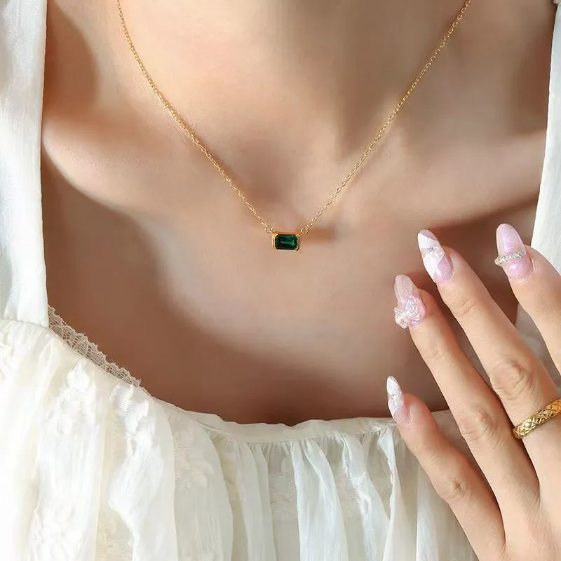 Women's gold geometric pendant necklace with quadrilateral design and inset cubic zirconia stones on chain