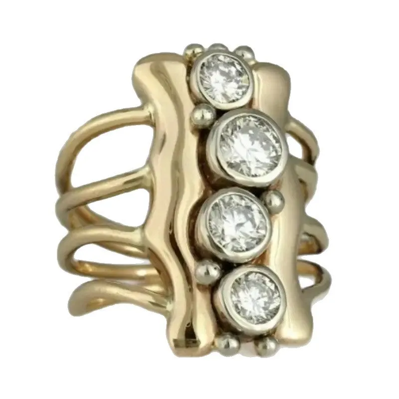 Gold electroplated zinc alloy retro creative fashion ring for women on a plain background