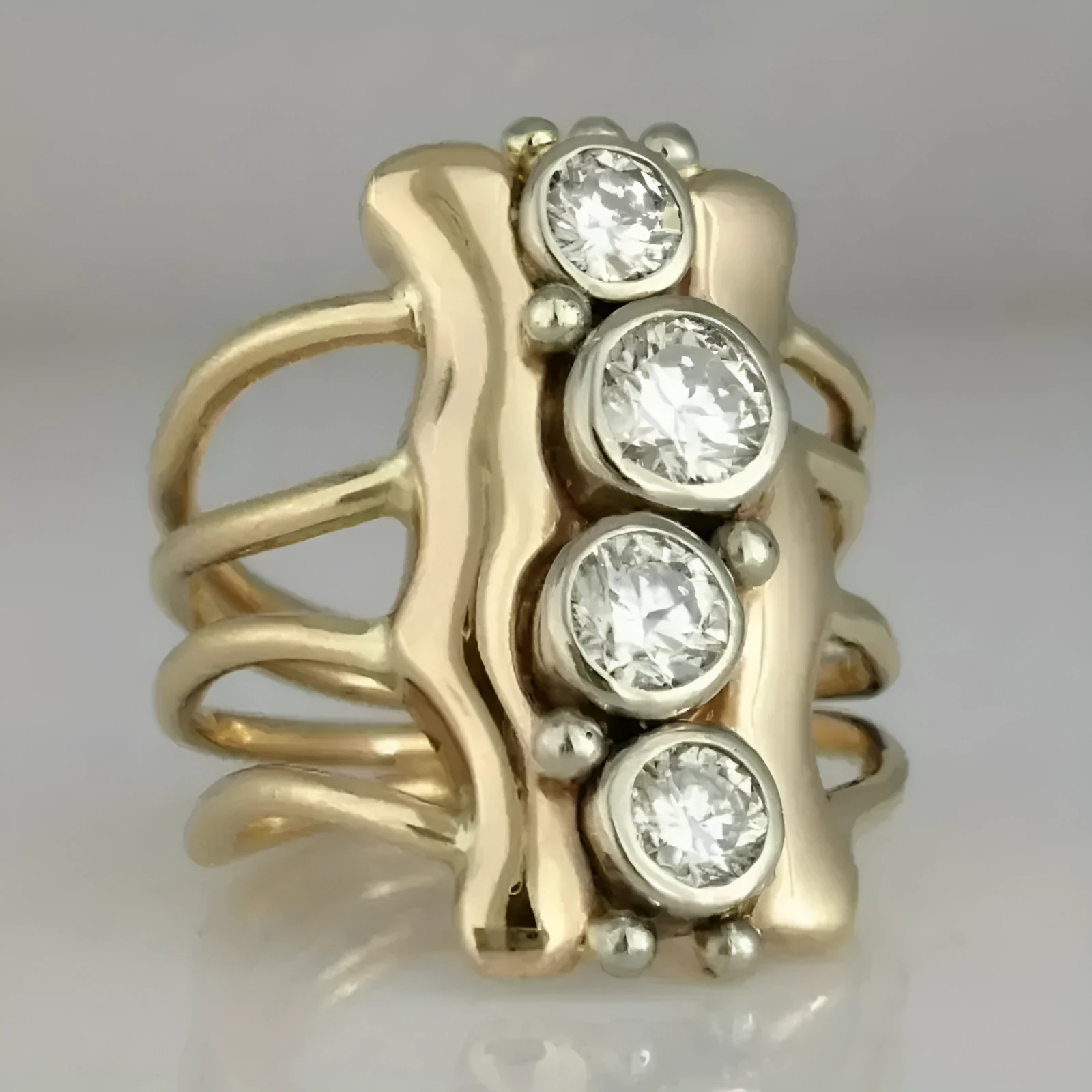 Gold electroplated zinc alloy retro creative fashion ring for women on a plain background