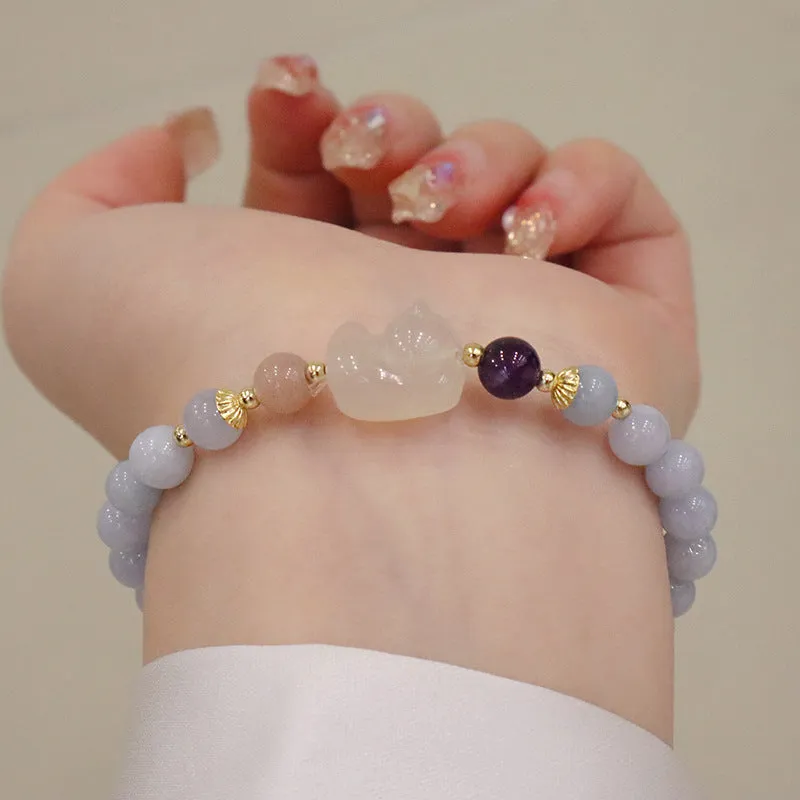 Women's gold-plated bracelet with artificial crystal and chalcedony pendant in climbing cat design