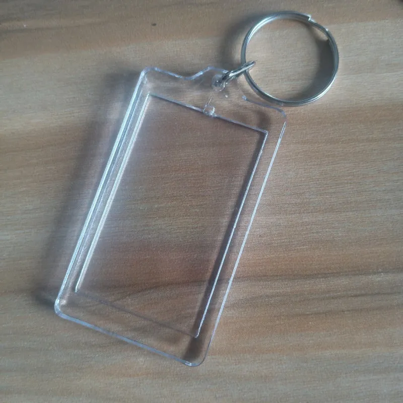 Transparent acrylic empty keychain shell in apple shape against a white background