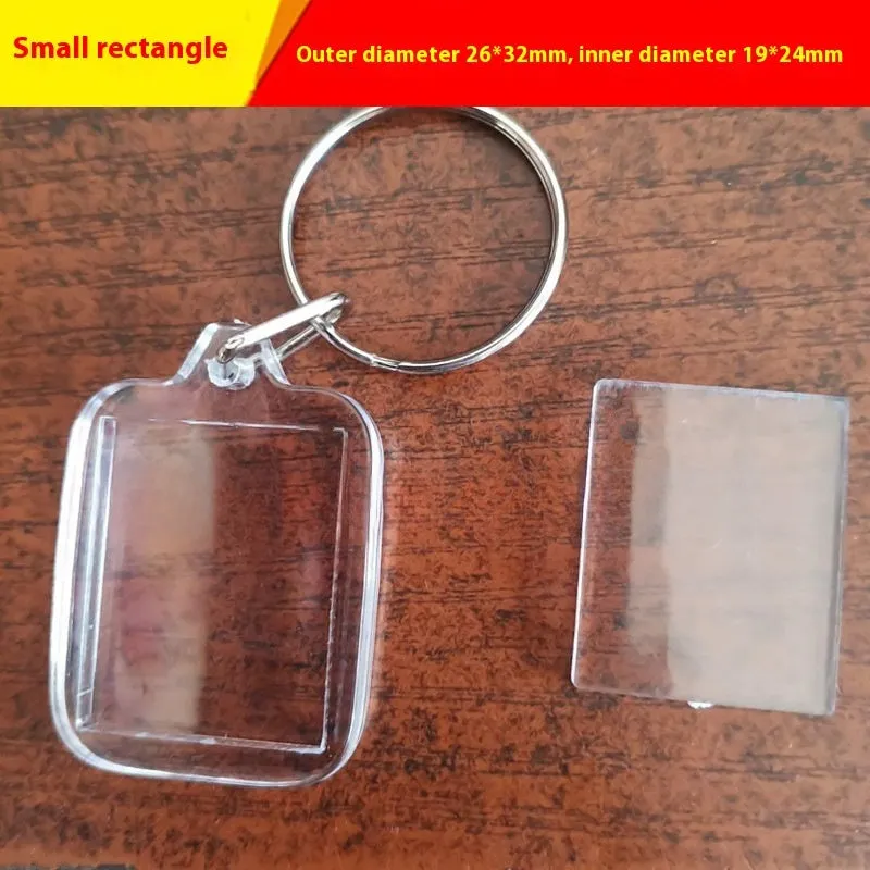 Transparent acrylic empty keychain shell in apple shape against a white background