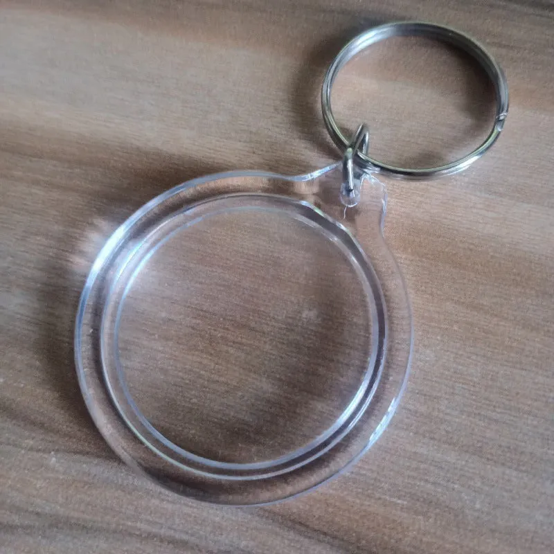 Transparent acrylic empty keychain shell in apple shape against a white background