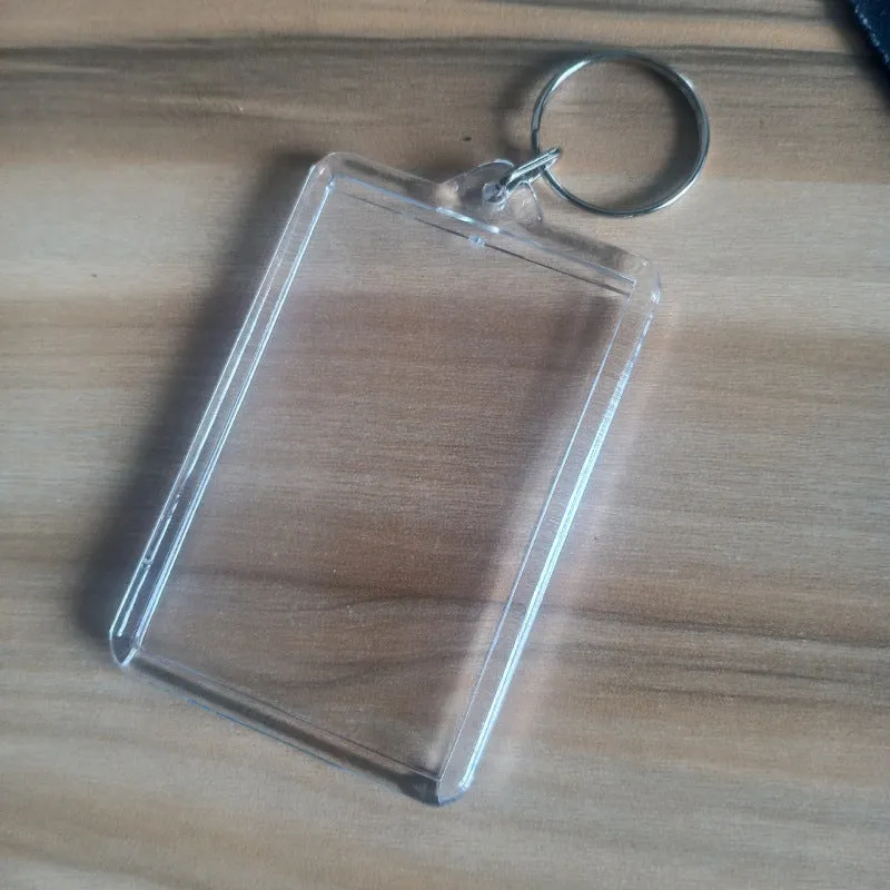 Transparent acrylic empty keychain shell in apple shape against a white background