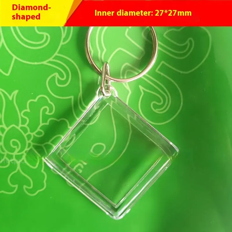 Transparent acrylic empty keychain shell in apple shape against a white background