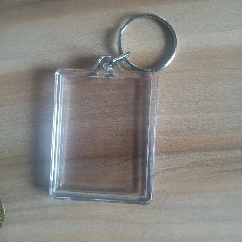 Transparent acrylic empty keychain shell in apple shape against a white background