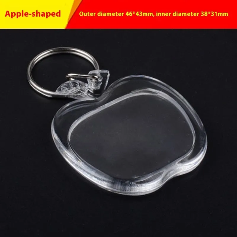 Transparent acrylic empty keychain shell in apple shape against a white background