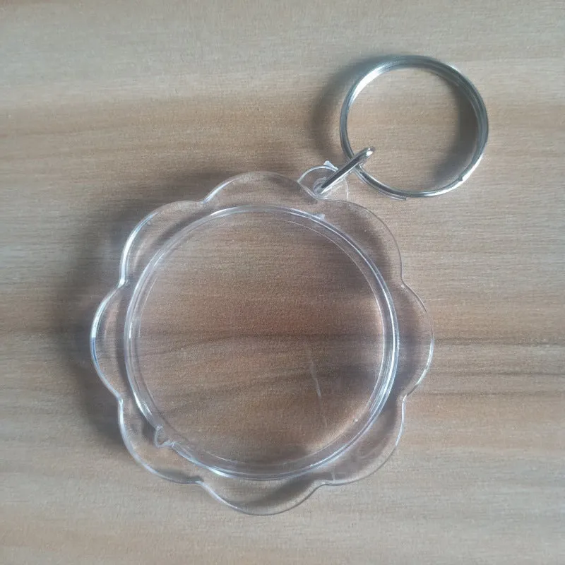 Transparent acrylic empty keychain shell in apple shape against a white background