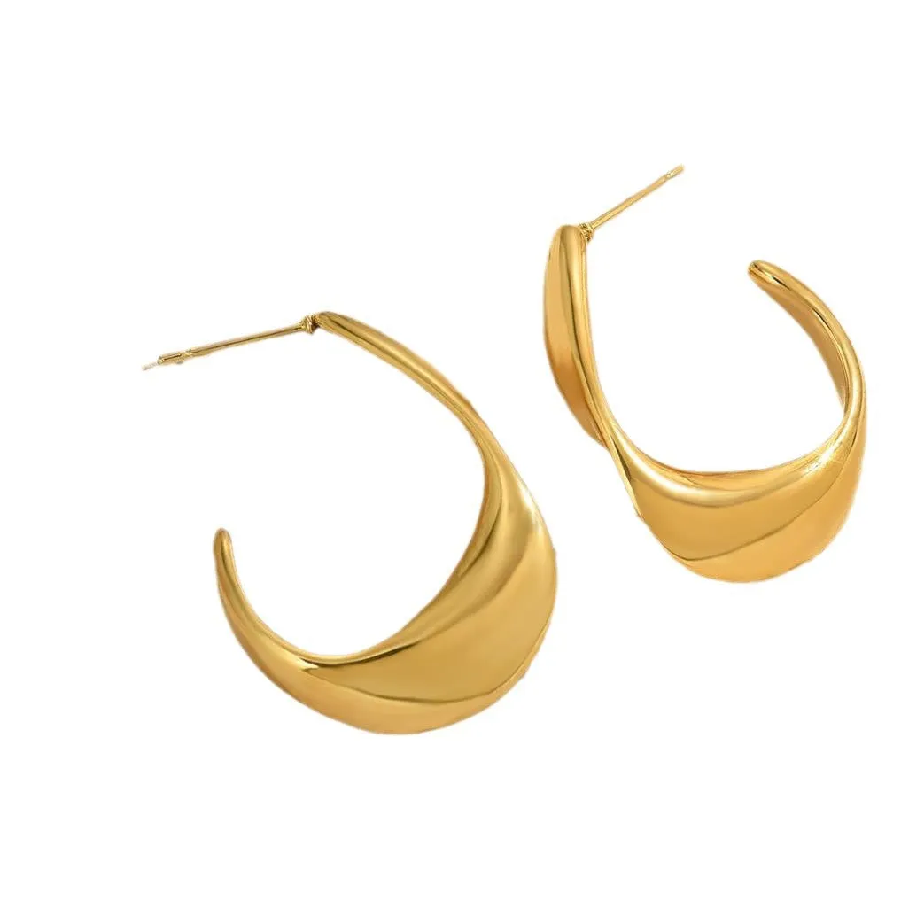 Geometric gold earrings with ring shape on stainless steel post-back closure against white background