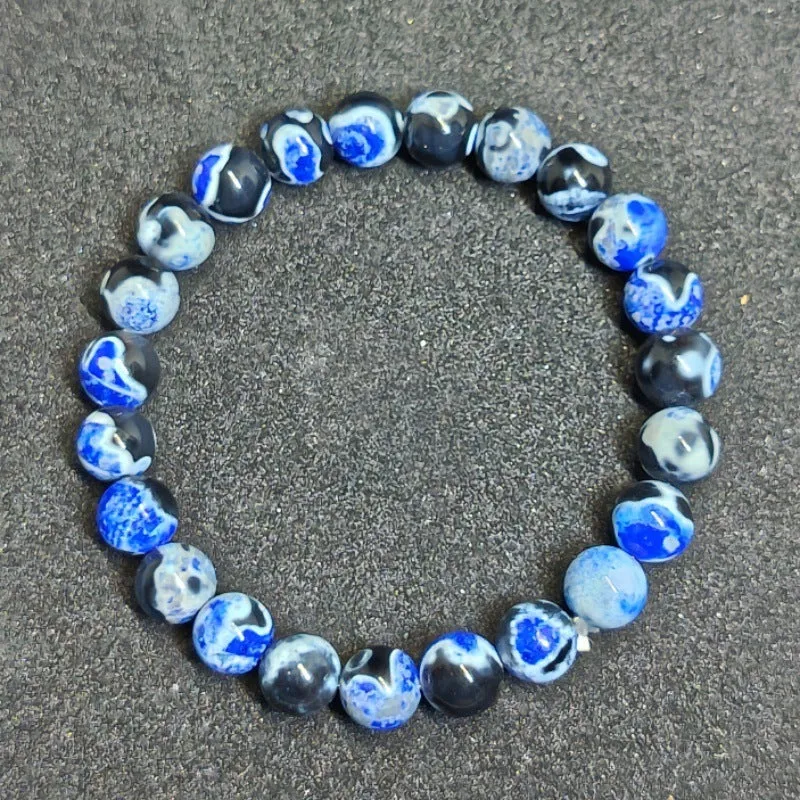 Close-up of a ladies bohemian bracelet with 8mm round glass beads in natural agate colours.
