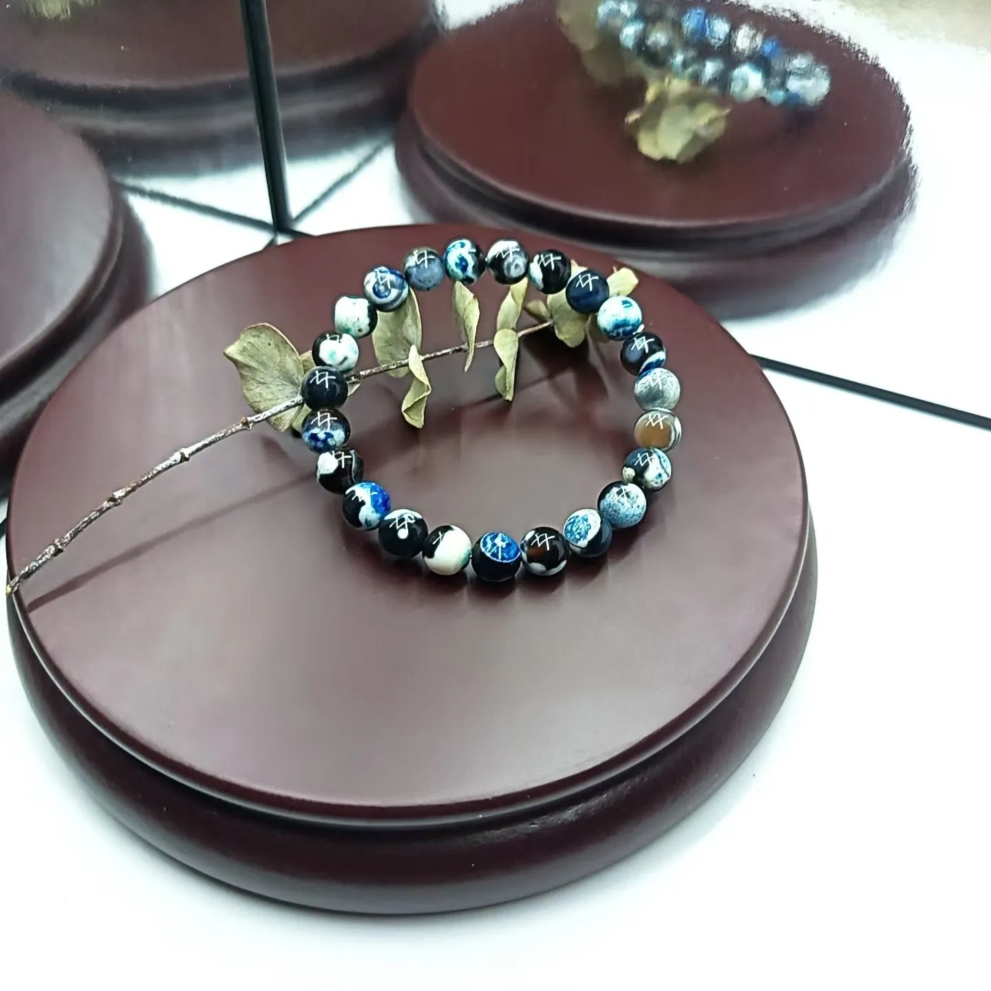 Close-up of a ladies bohemian bracelet with 8mm round glass beads in natural agate colours.