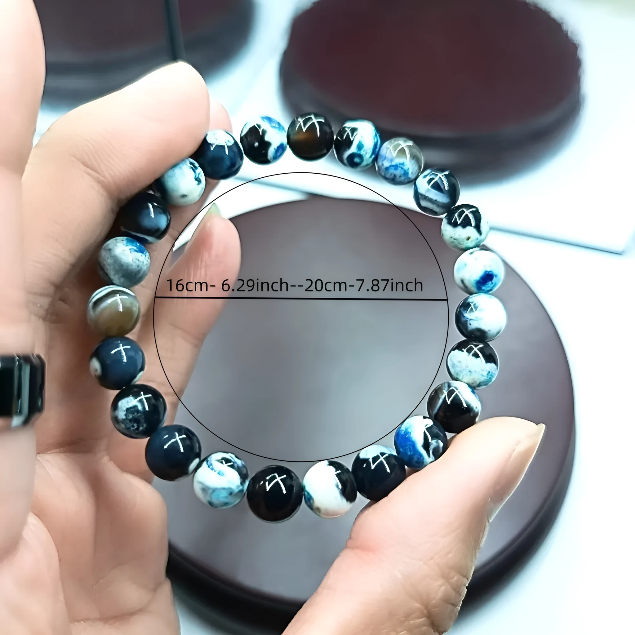 Close-up of a ladies bohemian bracelet with 8mm round glass beads in natural agate colours.
