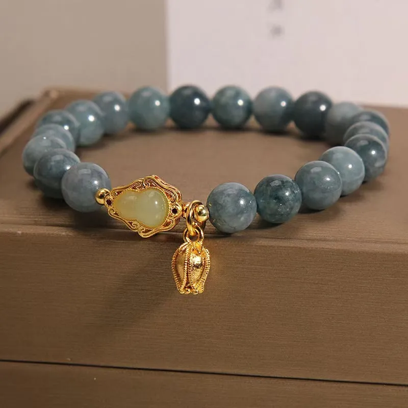 Sky blue natural stone gourd lotus flower pendant on a women's adjustable bracelet with electroplated metal.