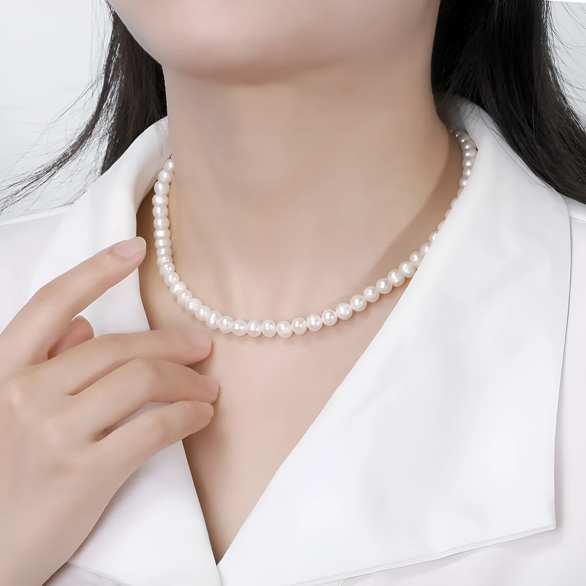 Women's silver necklace with round natural freshwater pearls on an adjustable chain.