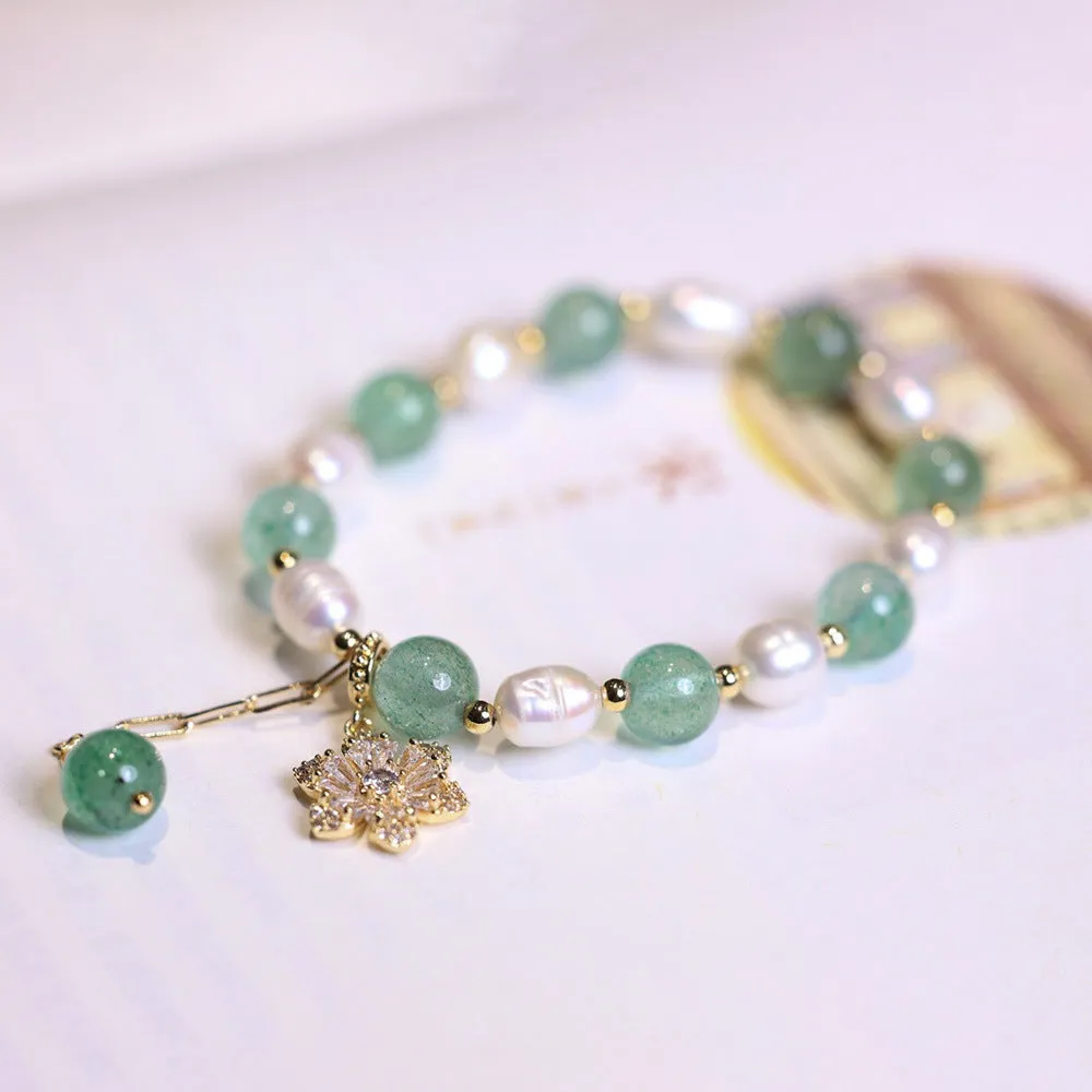 Green strawberry-shaped freshwater pearl bracelet with Chinese knot closure and small flower pendant