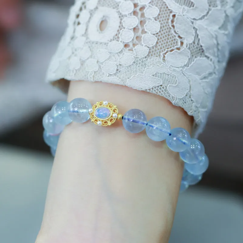 DIY adjustable aquamarine bead bracelet with pearl accents and a Chinese style fox Fengjiu charm.