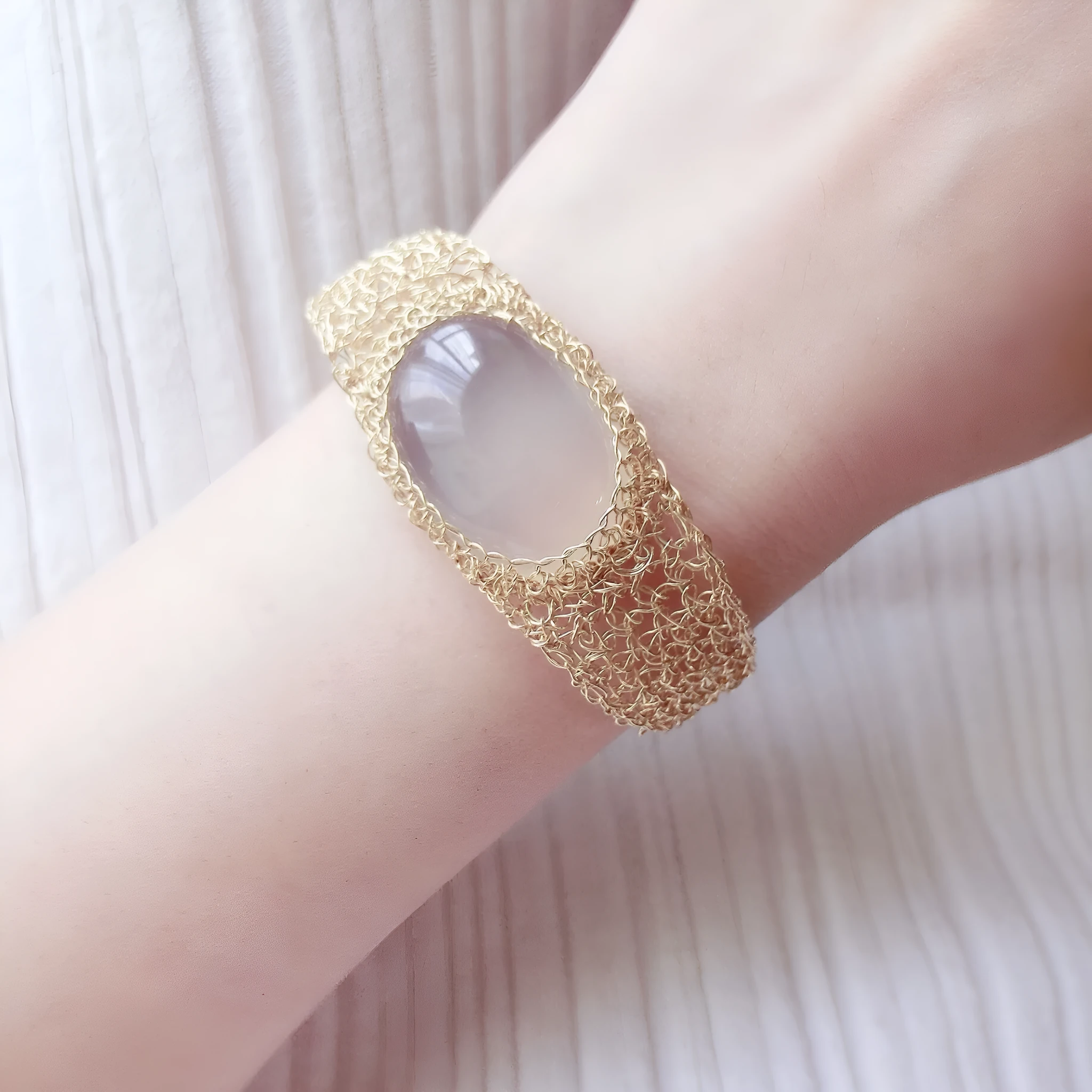 14k gold wire natural white chalcedony bracelet on wrist with adjustable chain closure