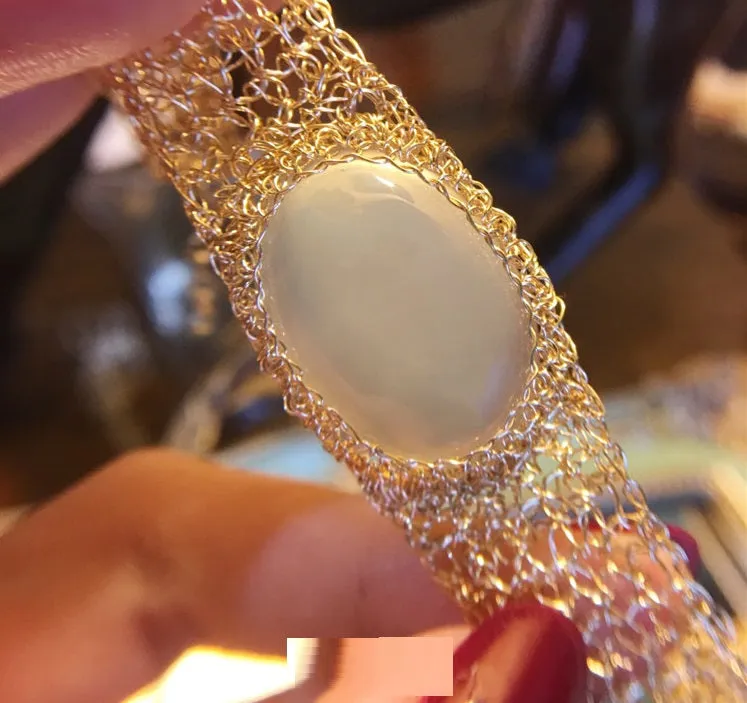 14k gold wire natural white chalcedony bracelet on wrist with adjustable chain closure