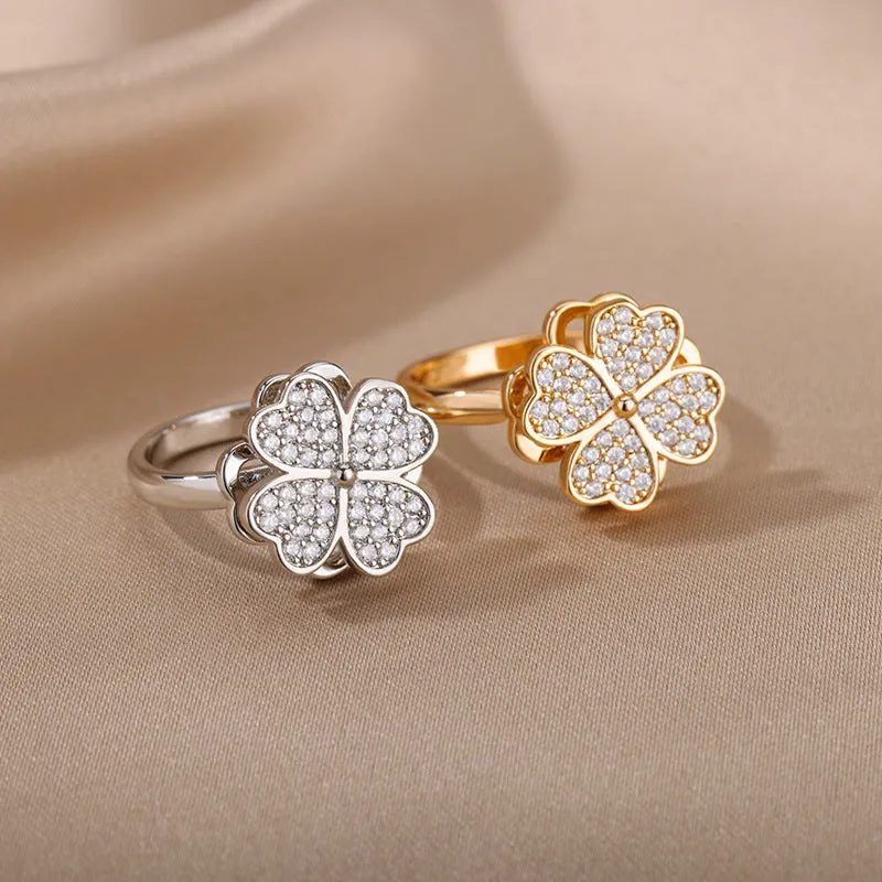 Rotatable flower ring with rhinestones on a woman's finger, available in gold or platinum finish