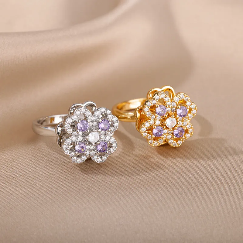 Rotatable flower ring with rhinestones on a woman's finger, available in gold or platinum finish