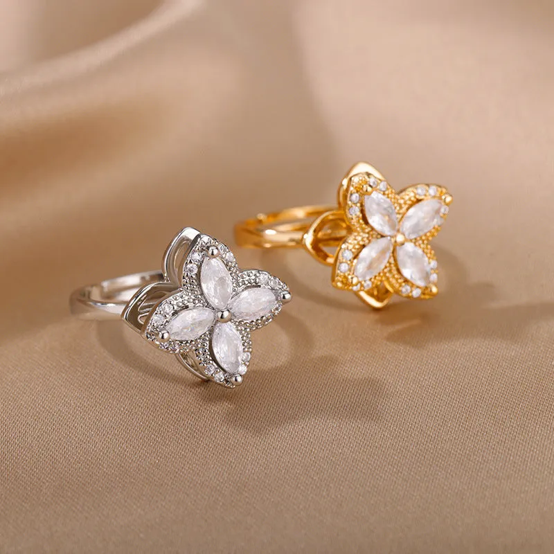 Rotatable flower ring with rhinestones on a woman's finger, available in gold or platinum finish