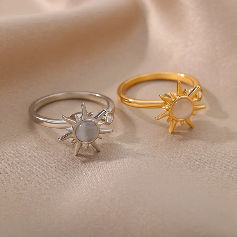 Rotatable flower ring with rhinestones on a woman's finger, available in gold or platinum finish