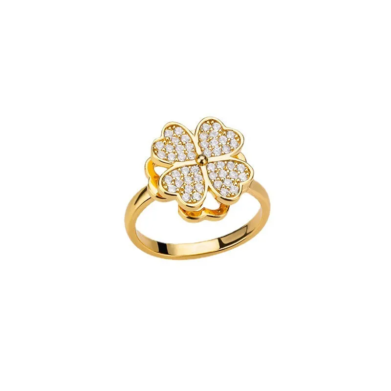 Rotatable flower ring with rhinestones on a woman's finger, available in gold or platinum finish