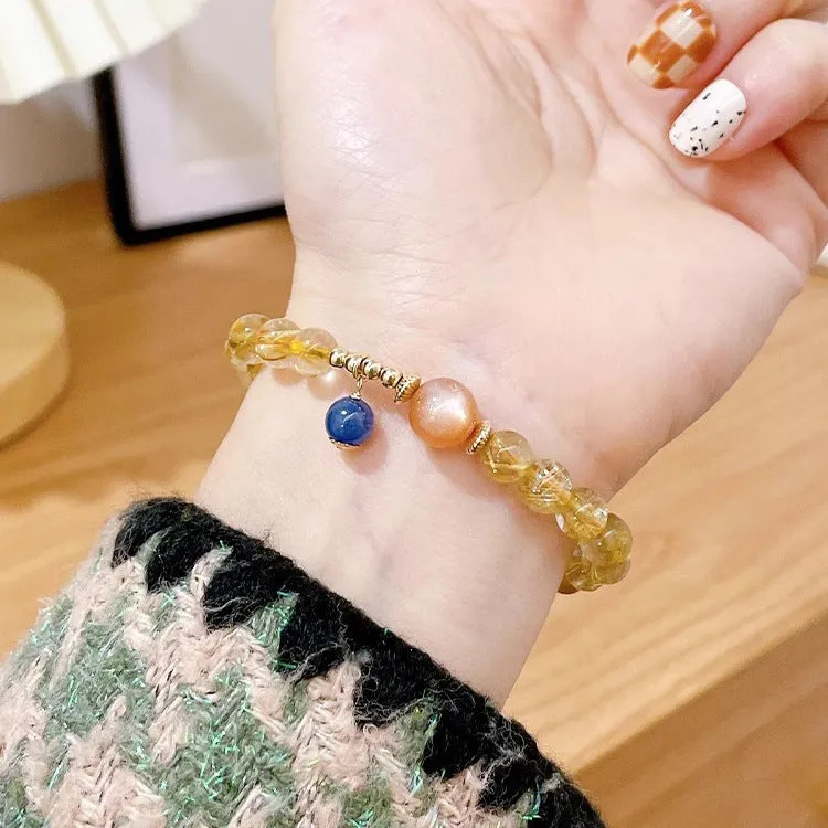 Women's gold rutilated quartz sunstone crystal bracelet with diamond-shaped and round beads